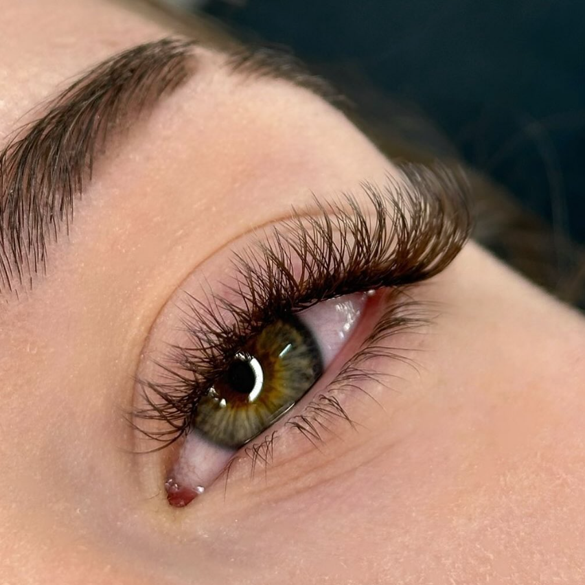 Close-up of a client's finished wispy lash extensions by Mylla